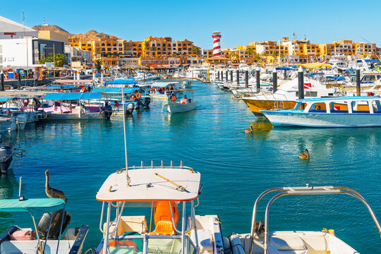 The colorful and busy cruise port with shops, cafes and boats in the marina along the Mexican Riviera at Cabo San Lucas, Mexico.