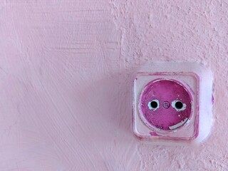 Vintage pink wall with rustic electrical outlet