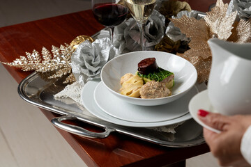 Elegant Escudella Soup on Silver Platter with Red Wine and Champagne – Refined Christmas Dining Scene