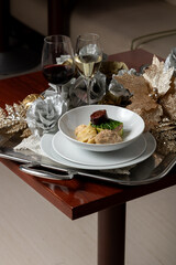 Elegant Escudella Soup on Silver Platter with Red Wine and Champagne – Refined Christmas Dining Scene