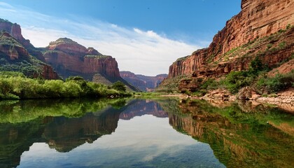 serene mountain canyon with towering rocks and lush greenery reflected in calm river waters