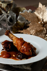 Braised Chicken with Prunes, Dried Peach and Pine Nuts on Silver Platter – Elegant Christmas Dining Scene with Champagne and Wine