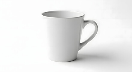 Fototapeta premium A plain white ceramic mug with a handle is shown against a stark white background.