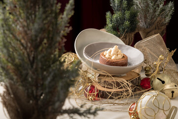 Festive Brownie with Nougat Mousse and Icing Sugar – Elegant Christmas Dessert in Warm Golden Setting