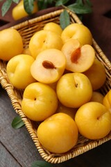 Ripe yellow cherry plums on wooden table, closeup