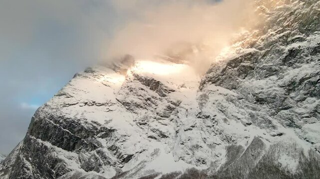 This footage captures the iconic, snow draped peaks and dramatic cliffs of this legendary Norwegian mountain range, bathed in the soft light of a winter day.