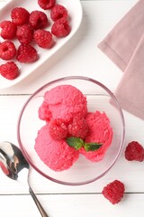 Delicious raspberry sorbet with mint in bowl, spoon and fresh berries on white wooden table, flat...