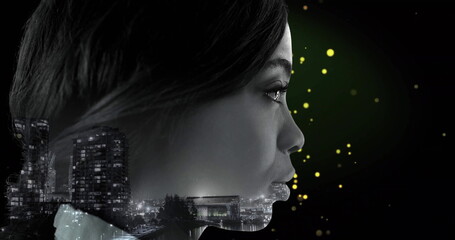 Merging silhouette with night city skyline in studio showcasing green glow and yellow orbs