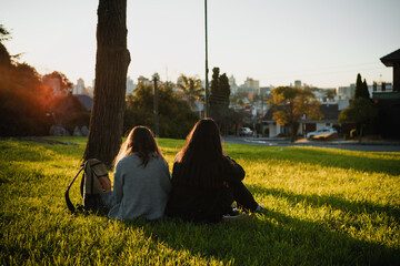 Friends enjoying a sunny day in the park having a picnic.