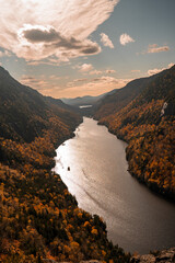 Up State New York in the Adirondack State Park during peak Fall Autumn season with golden maple...