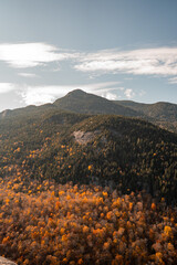 Up State New York in the Adirondack State Park during peak Fall Autumn season with golden maple...