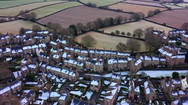 Rows of Houses and Surrounding Farmland in Haworth, West Yorkshire Aerial view of the village of Haworth in the Worth Valley in West Yorkshire, England on hazy day in winter. The village is famous fo