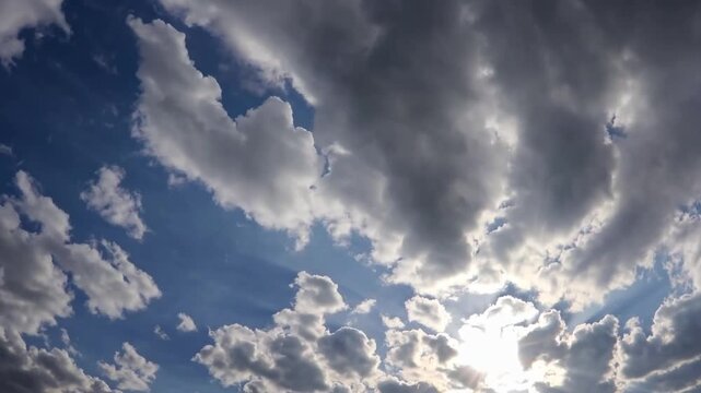 Scenic background filled with cumulus formations and rays of sunlight breaking through