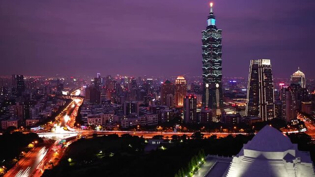 The cityscape of Taipei illuminated with purple light in the evening