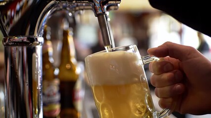 Close Up of Polished Chrome Tap Pouring Golden Beer into a Glass with Frothy Foam in a Lively Bar Setting Perfect for Decoration and National Beer Day Promotion Detailed Macro Shot and Smooth Motion