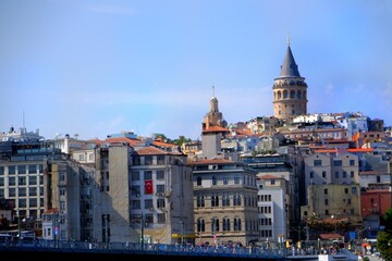 Obraz premium The historic Galata Tower, a tourism destination in Istanbul. Galata Bridge. General view of Karaköy. Historical buildings. Old buildings. Istanbul - Karaköy - Turkey.