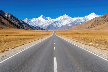 Fototapeta premium Asphalt Path to Majestic Snow-Capped Peaks