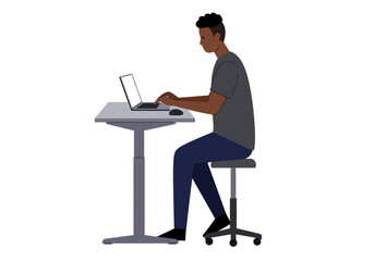 Focused Young Man Working on Laptop at Standing Desk.