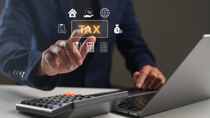 A person interacts with a digital interface displaying tax-related icons while using a laptop and calculator.
