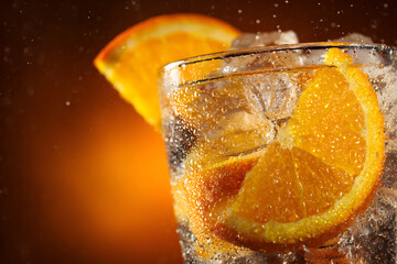 Refreshing Summer Drink with Ice, Orange Slices, and Radiant Glow