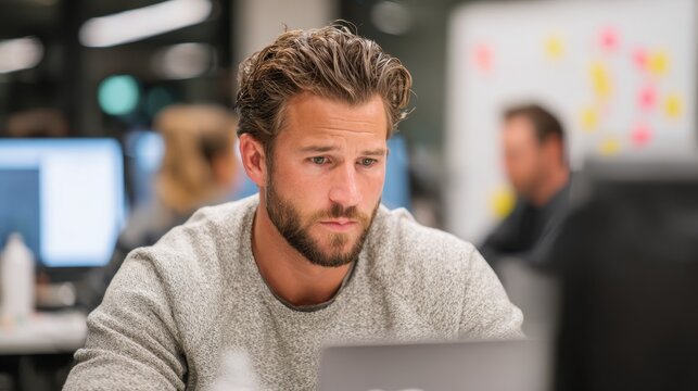 Developer reviewing FHIR API mapping code on a laptop during a team standup medium shot highlighting intense concentration with softfocused whiteboard and teammates.