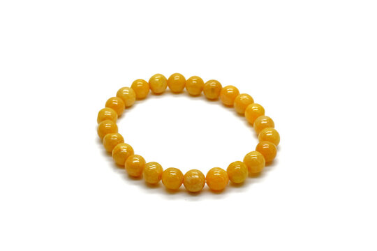 Yellow jadeite jade bracelet isolated on white background. Natural yellow color Burmese (Myanmar) jade bracelet type A, rosary