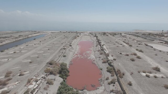 Raw D-Log Aerial Tracking Shot of Polluted Red Water Canal Leading to Salton Sea California