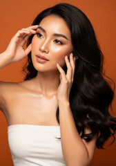 Fototapeta premium A portrait of an Asian woman with radiant skin and long, dark hair