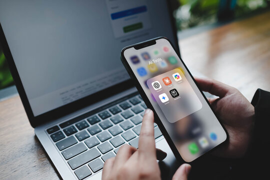 Bangkok, Thailand. August 23, 2025; A person opening a folder of popular AI tools on a smartphone, including ChatGPT, Gemini, Midjourney, and Perplexity.