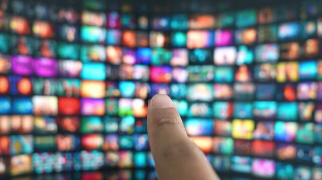 The act of choosing media with just a gesture on a big TV connects ideas of innovation, seamless user experiences, interactivity, entertainment diversity, and the smart integration of technology.
