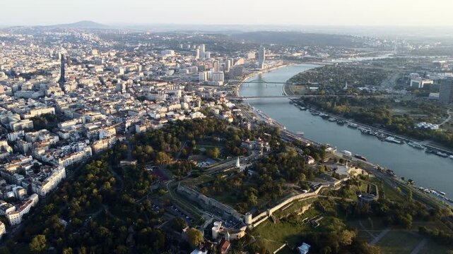 Aerial view over Belgrade's Kalemegdan fortress and river panorama at sunset.
