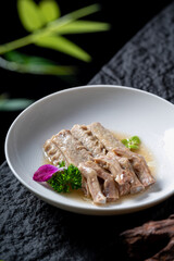 A plate of delicious cooked duck wings, beautifully presented with garnishes, showcasing a gourmet dish.