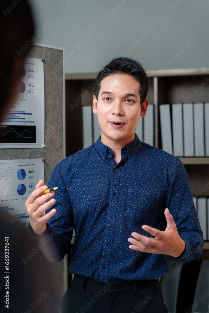 Poster young professional explaining data insights and charts on a whiteboard while collaborating with a co