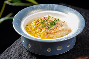A dish of steamed Chinese cabbage with delicate seasoning served in a stylish bowl, showcasing a fresh and appetizing appearance.
