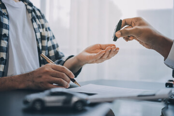 Car salesman gave the keys to the customers who signed the purchase contract legally, Successful...
