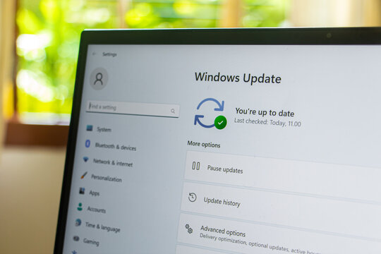 Yogyakarta, Indonesia, March 04, 2023 : Checking windows update on laptop screen close up view, Working home concept.