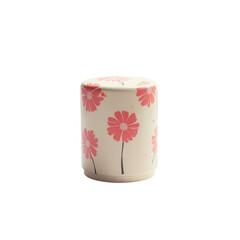 A cylindrical container, adorned with delicate pink flowers, sits against a stark black background.