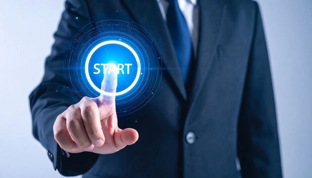 Businessman pressing a holographic start button