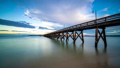 Obraz premium Coastal Wooden Pier at Sunset, Long Exposure
