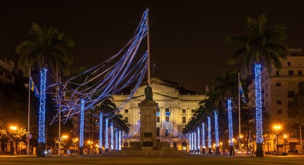 Obraz premium Night View of Illuminated Plaza with Monument and Palm Trees in Cartagena, Colombia