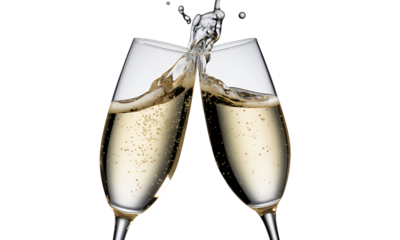 Two Champagne Flutes Toasting with Sparkling Wine, Festive Celebration Image