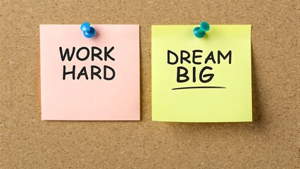 Two Sticky Notes Pinned to a Corkboard One with WORKHARD the Other with DREAMBIG pushpins