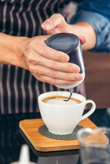 Vertical Horizon Close up hands coffee barista man make hot cup espresso shot from coffee machine. Vertical Cappuccino with milk italian cafe. Close up hands of barista make black hot coffee cup