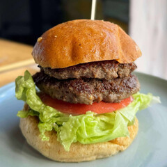 Juicy double burger with lettuce and tomato.