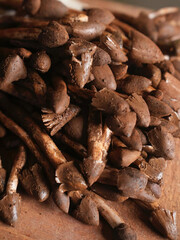 Fresh earthy mushrooms piled together on table.