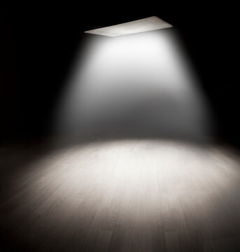 Backdrop of empty space room with misty ceiling light effect. Useful background. Haz light effect on floor.