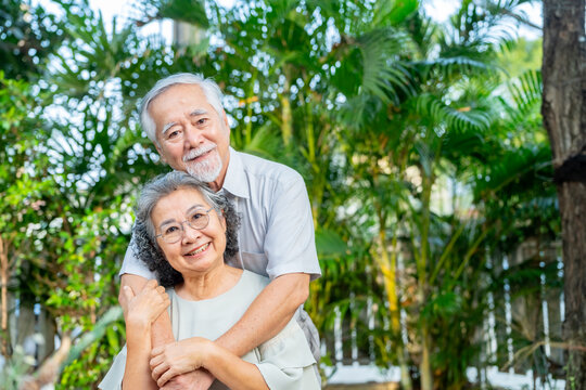 Happy Asian family senior couple enjoy leisure activity lifestyle relaxing and having afternoon tea party together in the garden at home. Elderly retired people healthcare and mental health concept.