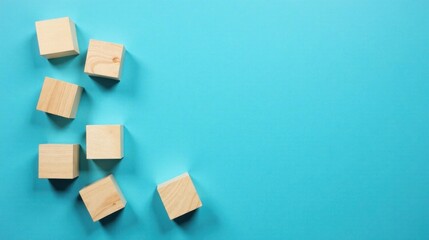 Obraz premium Wooden blocks scattered on a vibrant blue background, showcasing simple shapes and textures for design and branding applications