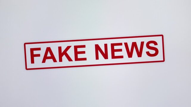 Animated Fake News stamp on a white background, close-up, red Fake News stamp.