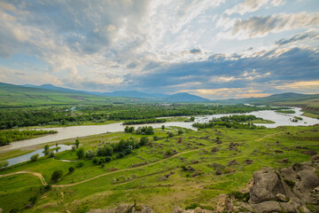 Scenic sunset views looking across the Kura River from the top of the ancient rock town of Uplistsikhe near the city of Gori, Georgia © hyserb